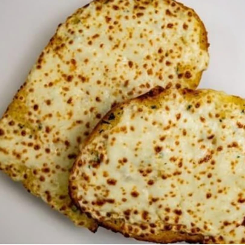Two slices of cheesy garlic bread, golden brown and covered in melted mozzarella, on a white surface.